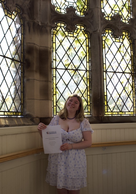 Emily standing in front of a window in the New King's Building