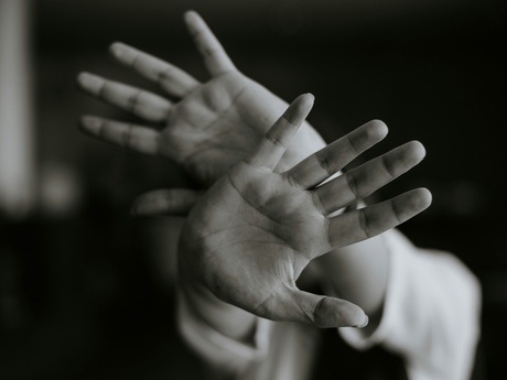 Black and white image of a pair of crossed hands