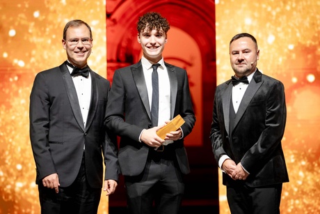 Award winners posing on a podium