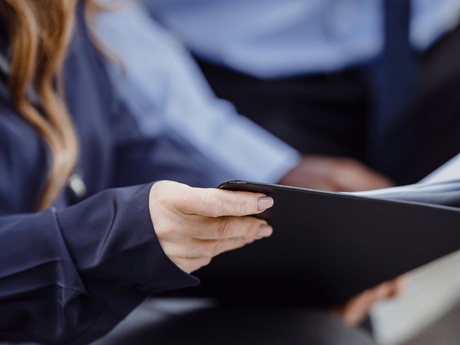 A blurred image of a man and a woman with a document