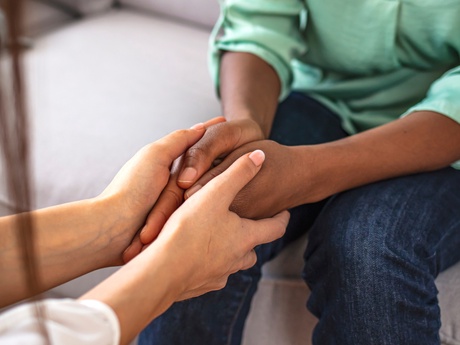 Two people holding hands