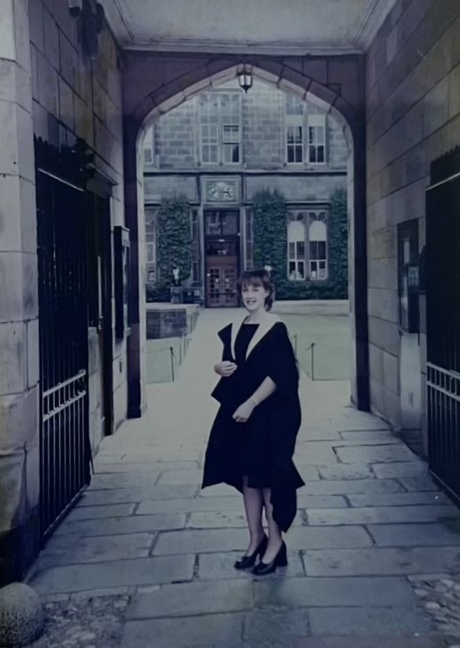 Shona in the same spot as the previous photo, but on her graduation day in 2000, wearing her cap and gown