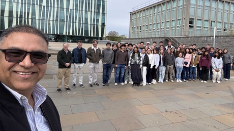 A group of people posing in front of Sir Duncan Rice Library at the University of Aberdeen