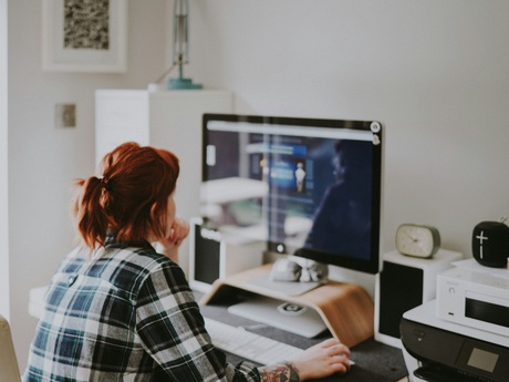 A woman working on a computer at home