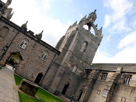 Exterior of King's College with a cloudy sky in the background