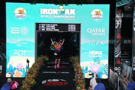 A runner celebrating crossing the finish line
