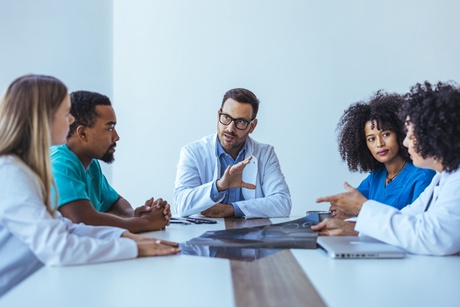 Medics sitting at a table having a discussion