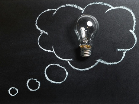 Graphic of a thought bubble on a chalk board with a lightbulb inside it