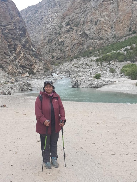 A person standing beside an alpine lake