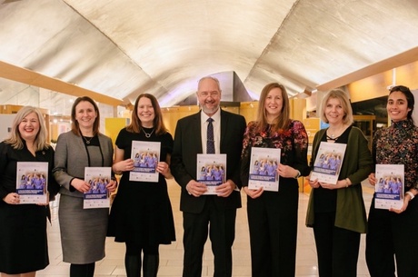 Group standing with the white paper