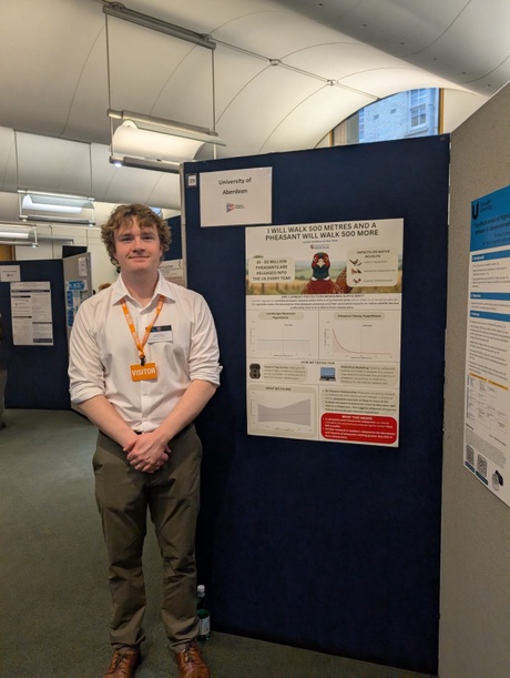 Student Joe stood beside his research poster titled &ldquo;I Will Walk 500 Metres, and a Pheasant Will Walk 500 More&rdquo;