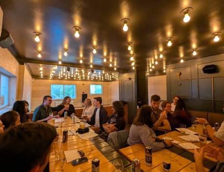 Lauren and others who attended the NoWPaS workshop sat at tables deep in discussion