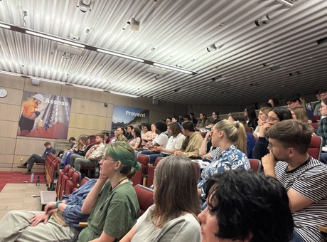 A group of people sat watching a lecture