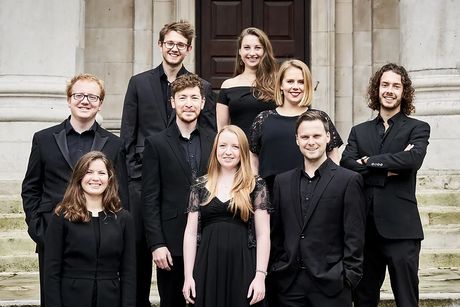 Members of Siglo de Oro in formal attire, standing in front of a building