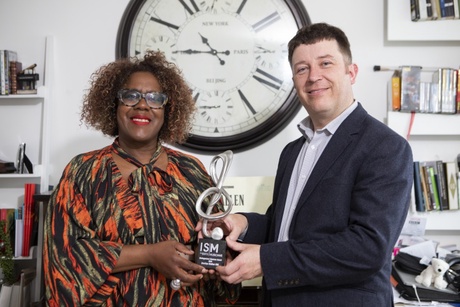 Errollyn Wallen receives an award from Chris Collins