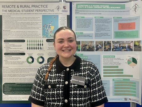 Ashley stood in front of her project poster