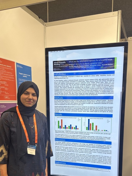 A student stood beside a screen