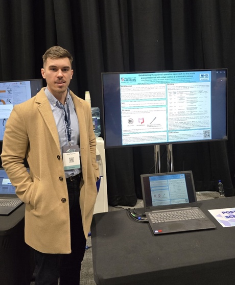 Josip stood beside his research poster