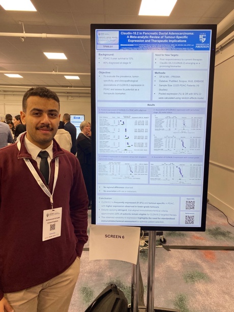 Mohammed stood beside his research poster