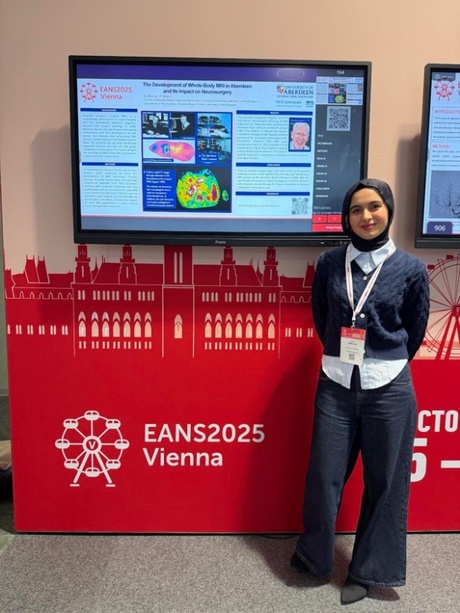 Rawan stood beside her poster