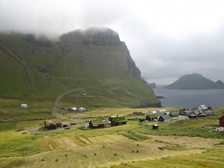 Panoramic view of Gasadalur village in the mist surrounded by mountain and sea