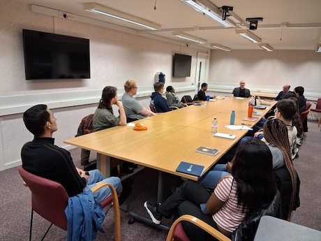 People at the meeting around a table.