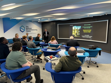 An audience listening to a talk by Professor John Underhill