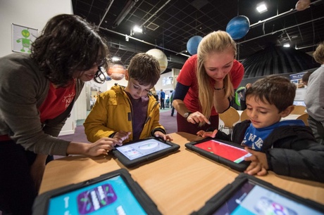 Image of family taking part in an interactive activity with a tablet as part of a previous Explorathon Discovery Day