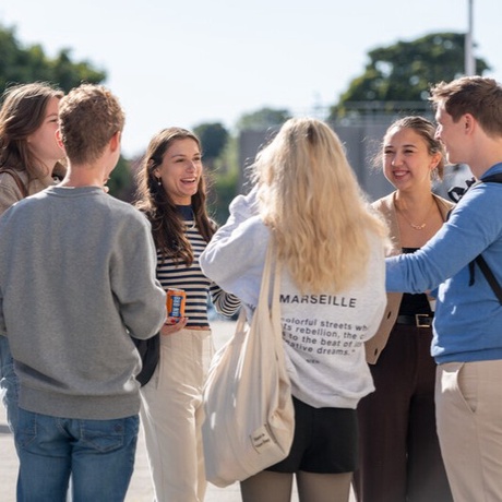 Image of students standing in group talking