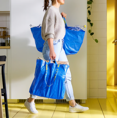 Photograph of person holding ikea bag