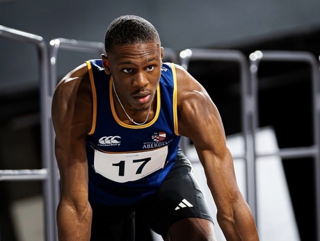 Sprinter Bradley Francis in starting block position wearing athletics bib no. 17