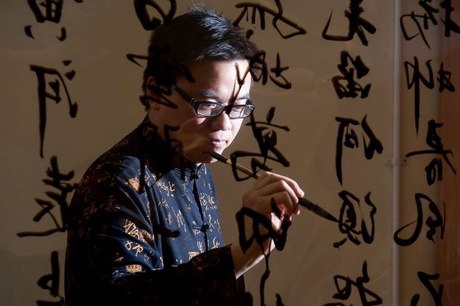 Person painting Chinese Calligraphy