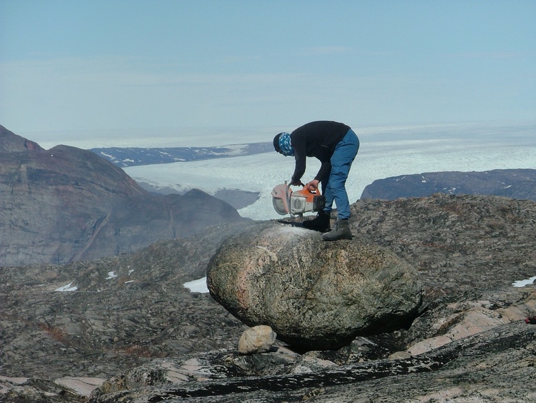 Brice sampling a boulder for cosmogenic exposure age dating to reconstruct the deglaciation history of the Greenland Ice Sheet, Uummannaq Fjord, West Greenland.