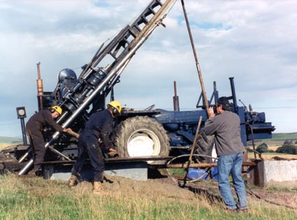 Drilling rig at Rhynie in 1997. The drilling crew on the left  are removing a section of core barrel which encloses a 50mm diameter length of rock or 'core' taken from the Rhynie chert sequence.