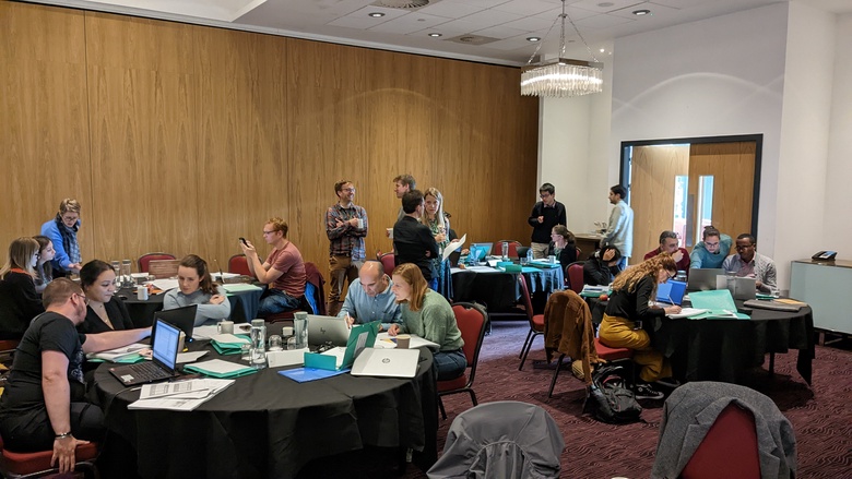 Photograph of course participants engaged in group work at the 2022 DCE course in Aberdeen.