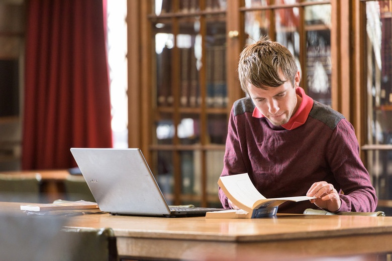 Man looking at book in Library