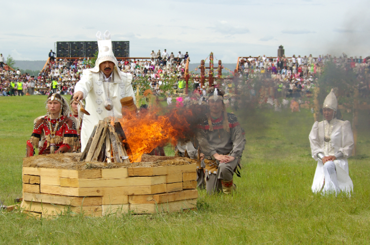 A shamanic practitioner feeds the fire. Photo courtesy of Maksim Unarov