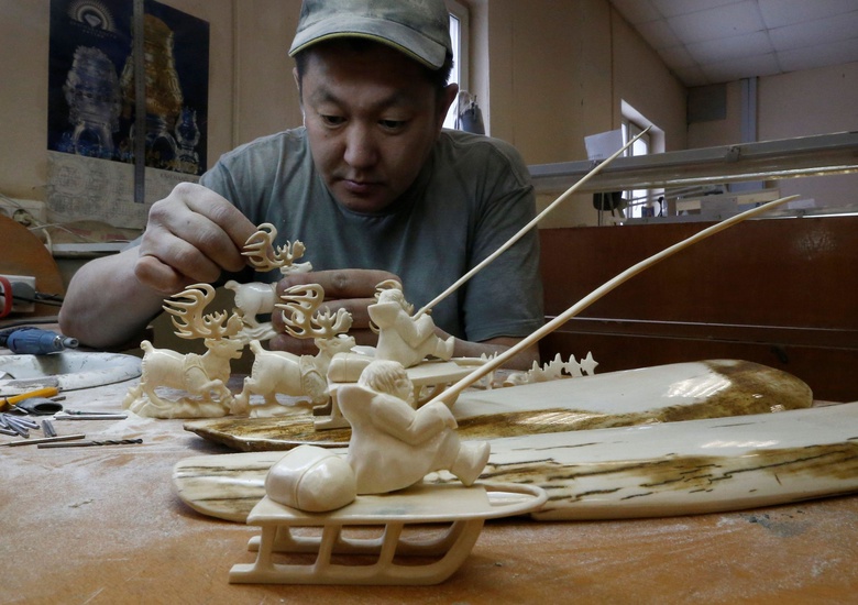 A Iakut master carves mammoth ivory