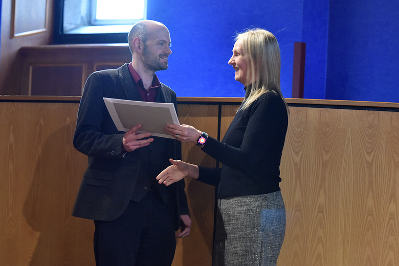 Dr Malcolm Harvey receiving the Highly Commended poster from Professor Ruth Taylor