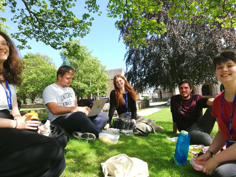 a photo of the 2019 Aberdeen Interns relaxing on Elphinstone Lawn
