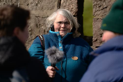 Photograph of a woman holding a microphone