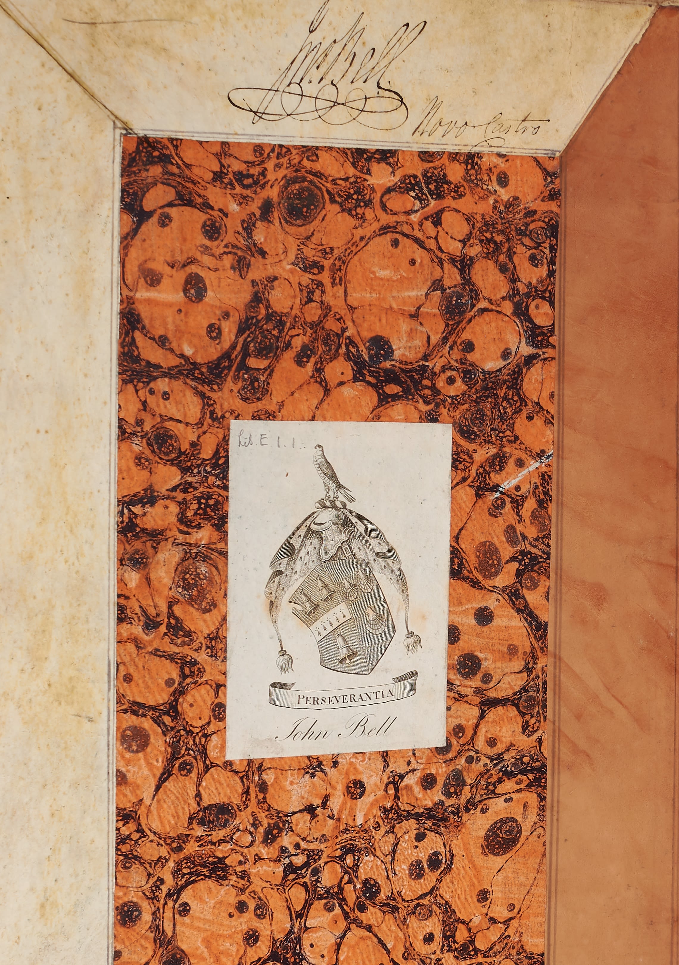 The inside cover of a volume of chapbook items with a book-plate with John Bell’s name and crest.