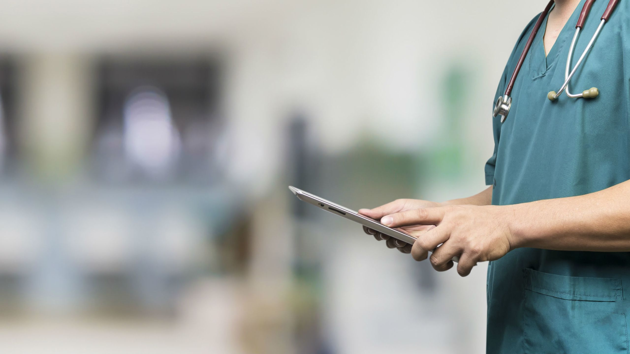 NHS worker holding tablet