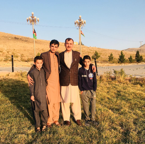 Ahmad with his family in Afghanistan where he hopes one day to return 