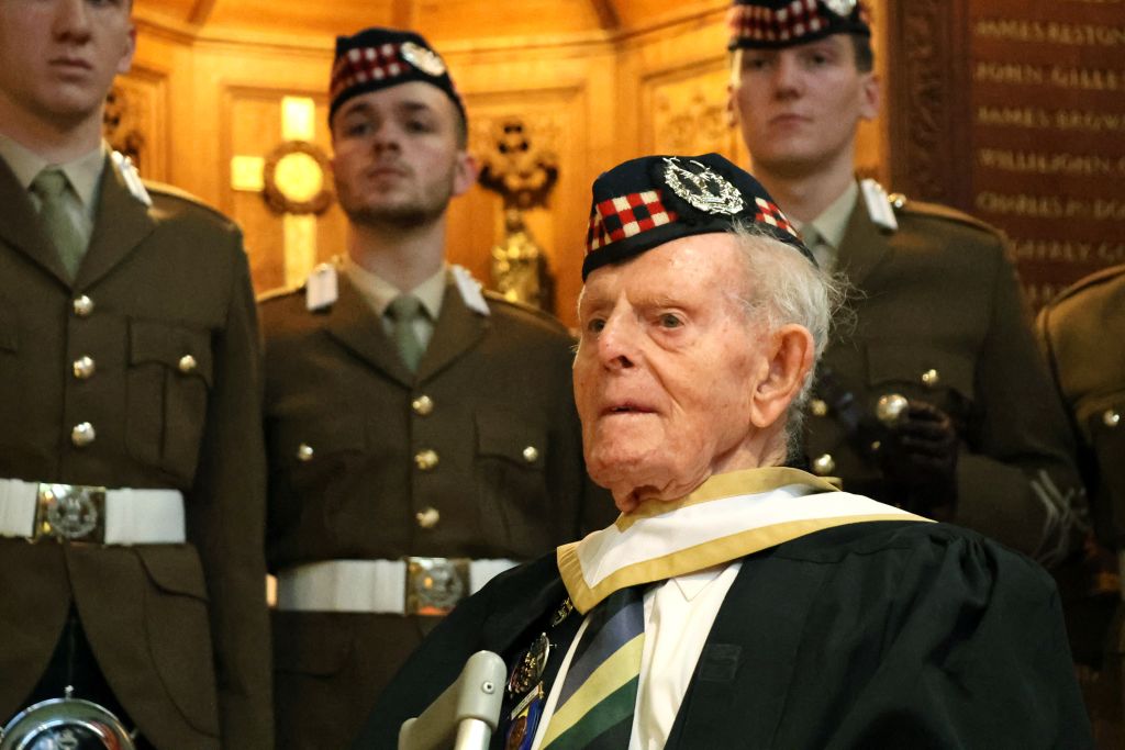 Jim Glennie with soldiers behind him