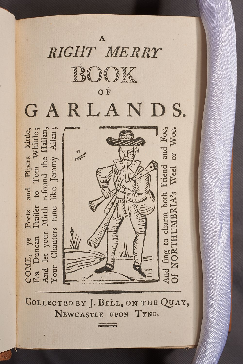 A printed image of a piper under the heading ‘Book of Garlands.’