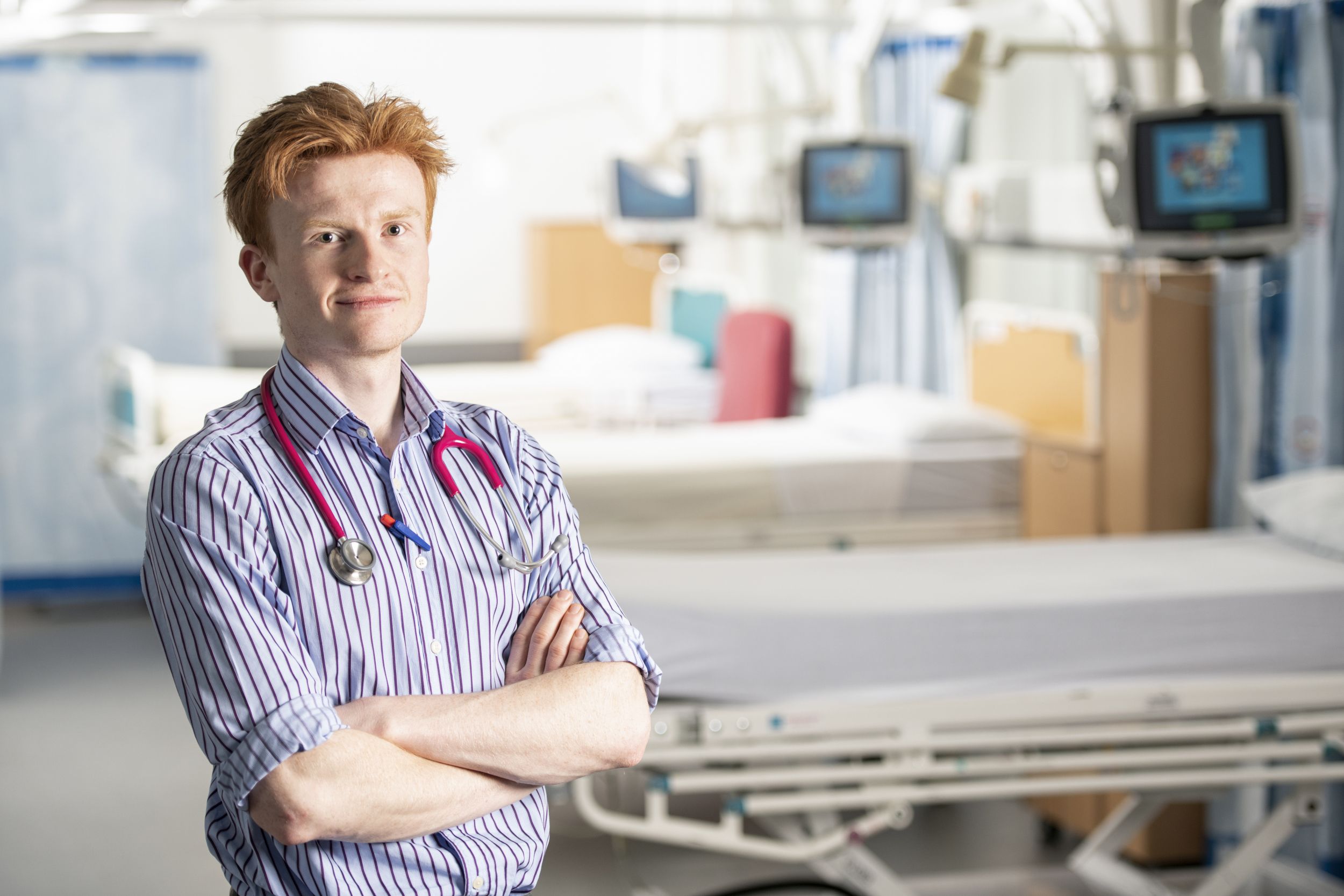 Photo of Seb Siegrist with a hospital ward in the background.
