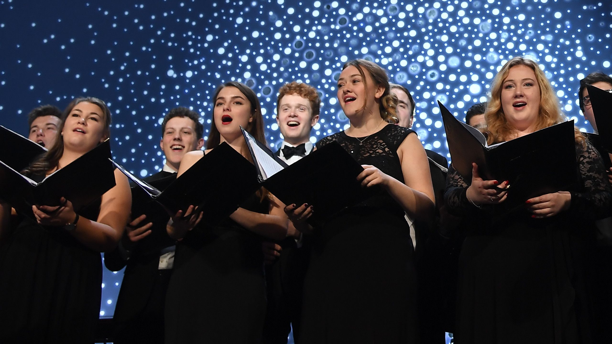 Photo of the University Chapel Choir on stage at the Snowflake Ball.